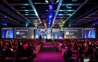 Attendees of a Corporate event facing the stage