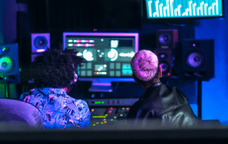 Two men working with Mixer or DJ Software at the Studio
