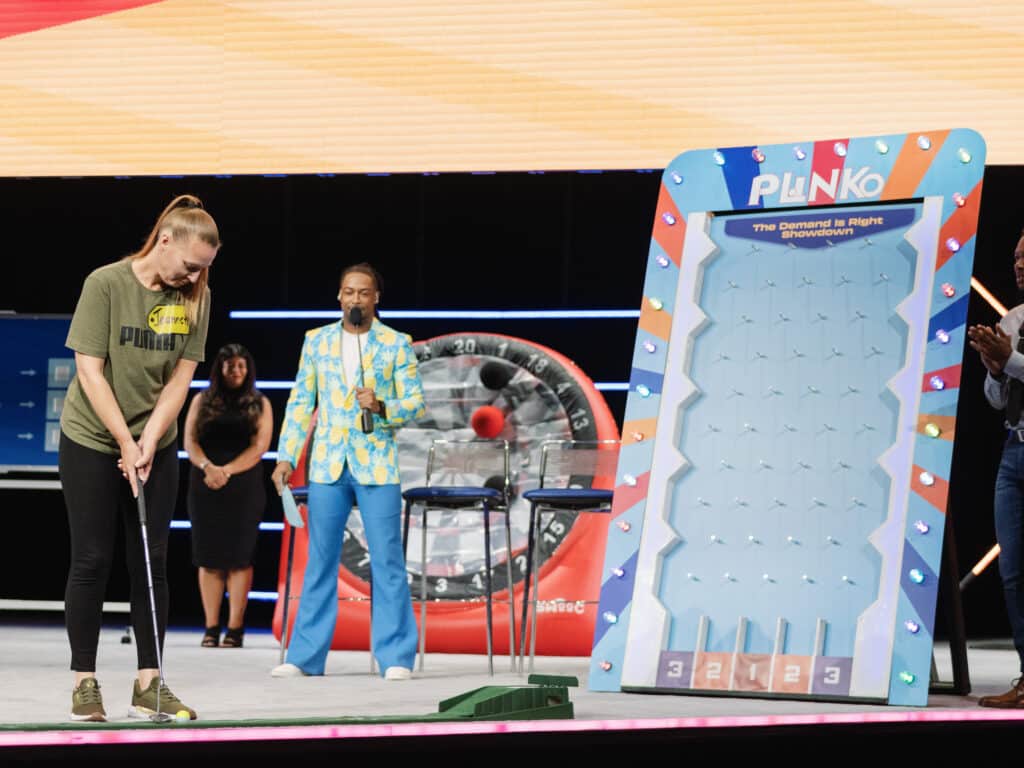 Corporate DJ Will Gill hosted an interactive game on stage with the player aiming for a golf ball like game