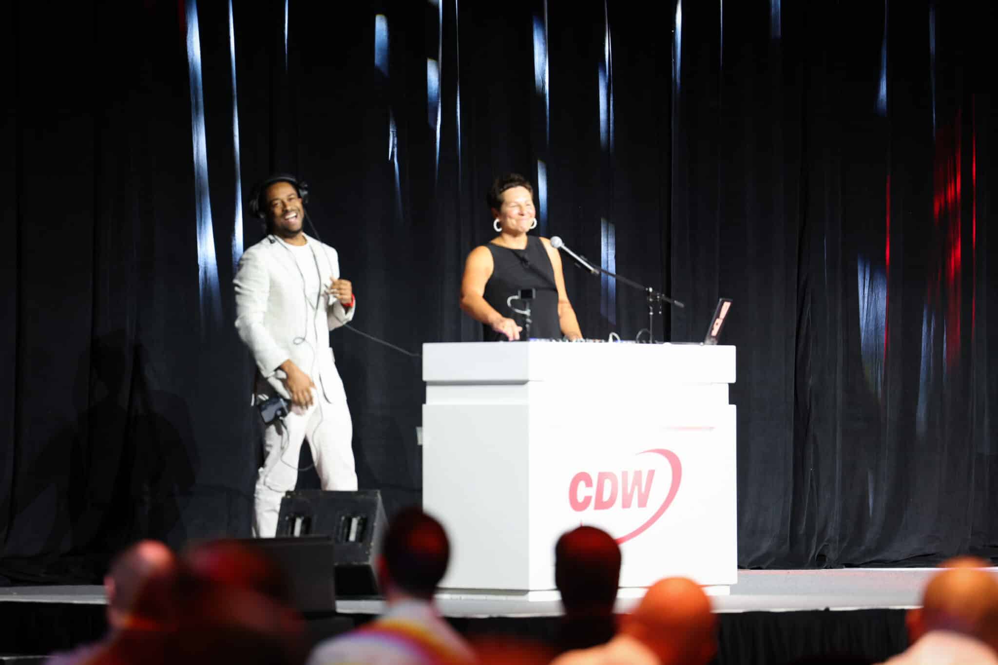 Orlando Corporate Eventt DJ Will Gill onstage teaching CDW President Chirs Leahy how to DJ