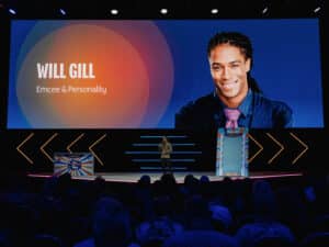 Miami Corporate Event MC Will Gill is onstage talking with a picture of him on the big screen