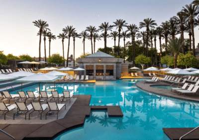 Scottsdale Hyatt Regency Scottsdale Resort & Spa pool with sun bathing chairs and palm trees