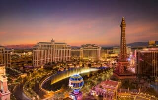 Las Vegas aerial view multiple buildings filled with lights and a fountain a globe filled with lights