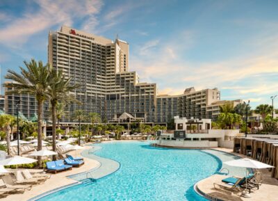 Marriott Orlando World Center building with Pool and Palm trees