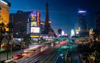 Multiple buildings at night filled with lights