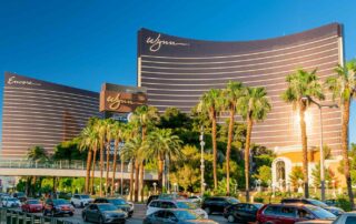 Wynn Building in Las Vegas Palm trees and multiple cars
