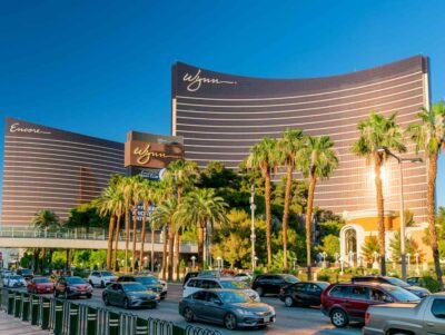 Wynn Building in Las Vegas Palm trees and multiple cars