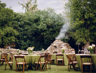 color geen tables with chairs and white flowers