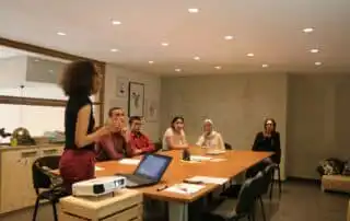 People in a meeting for sales kickoff games