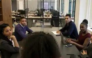 A group of people on a meeting in how to create marketing presentation for sales kickoff