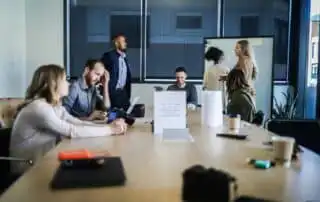 People in a meeting discussing 20 creative sales kickoff awards for their team