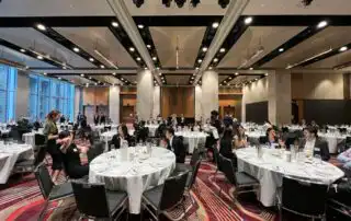 People sitting in a table discussing What are the best questions to ask at sales kickoff