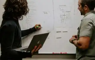 Two people discussing about sales kickoff speech ideas