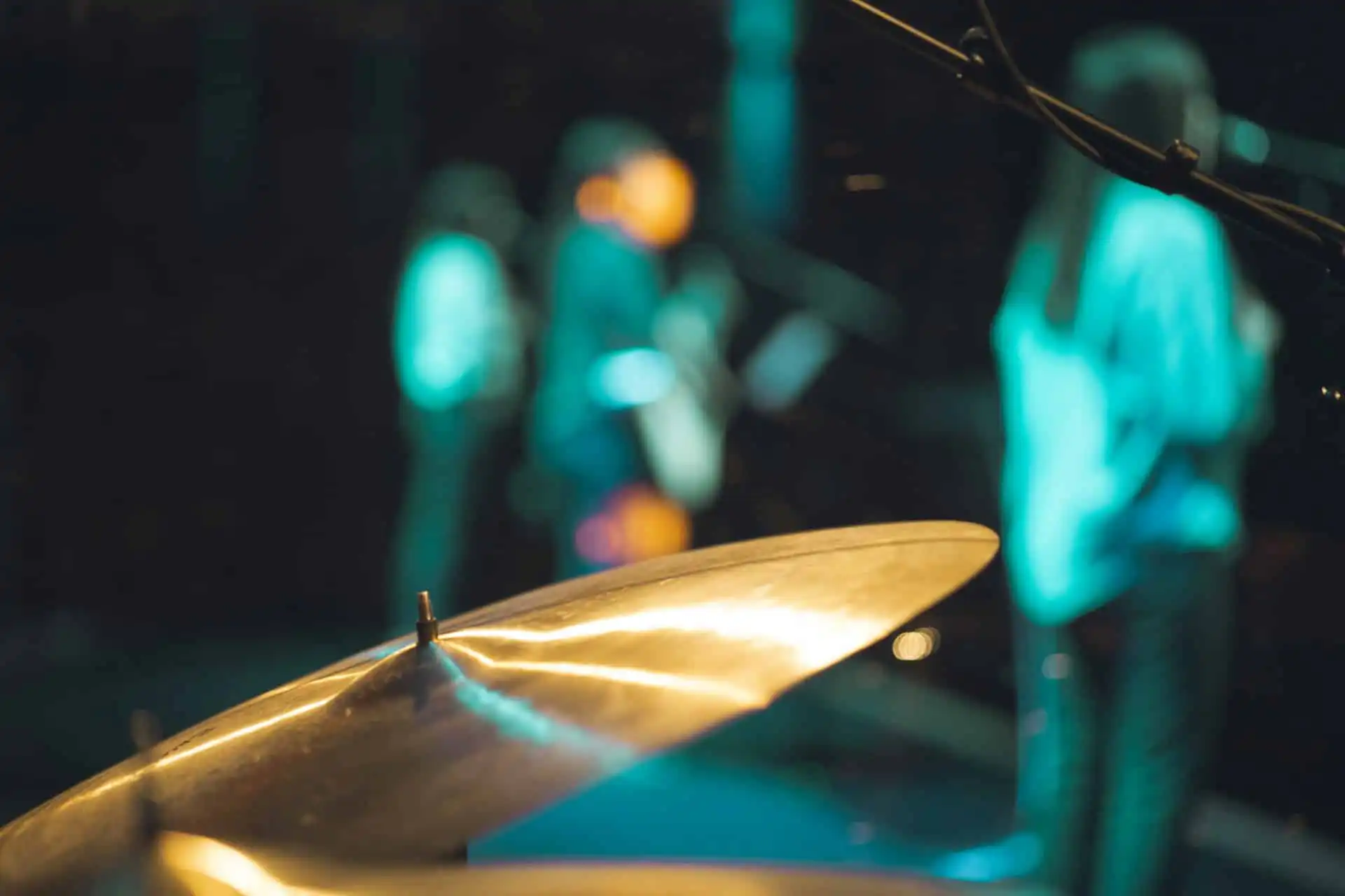 A drum and three people that's a member of corporate band