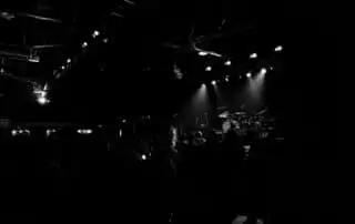 People in facing the stage waiting for the band to perform