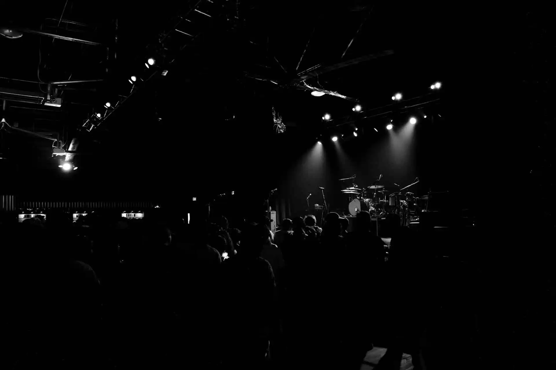 People in facing the stage waiting for the band to perform