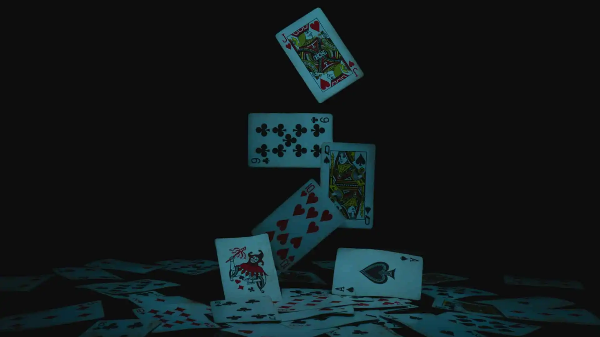 Magicians Floating playing cards including Jack of Hearts, Nine of Clubs, Queen of Spades, Ten of Hearts, Ace of Spades, and a Joker, against a dark background