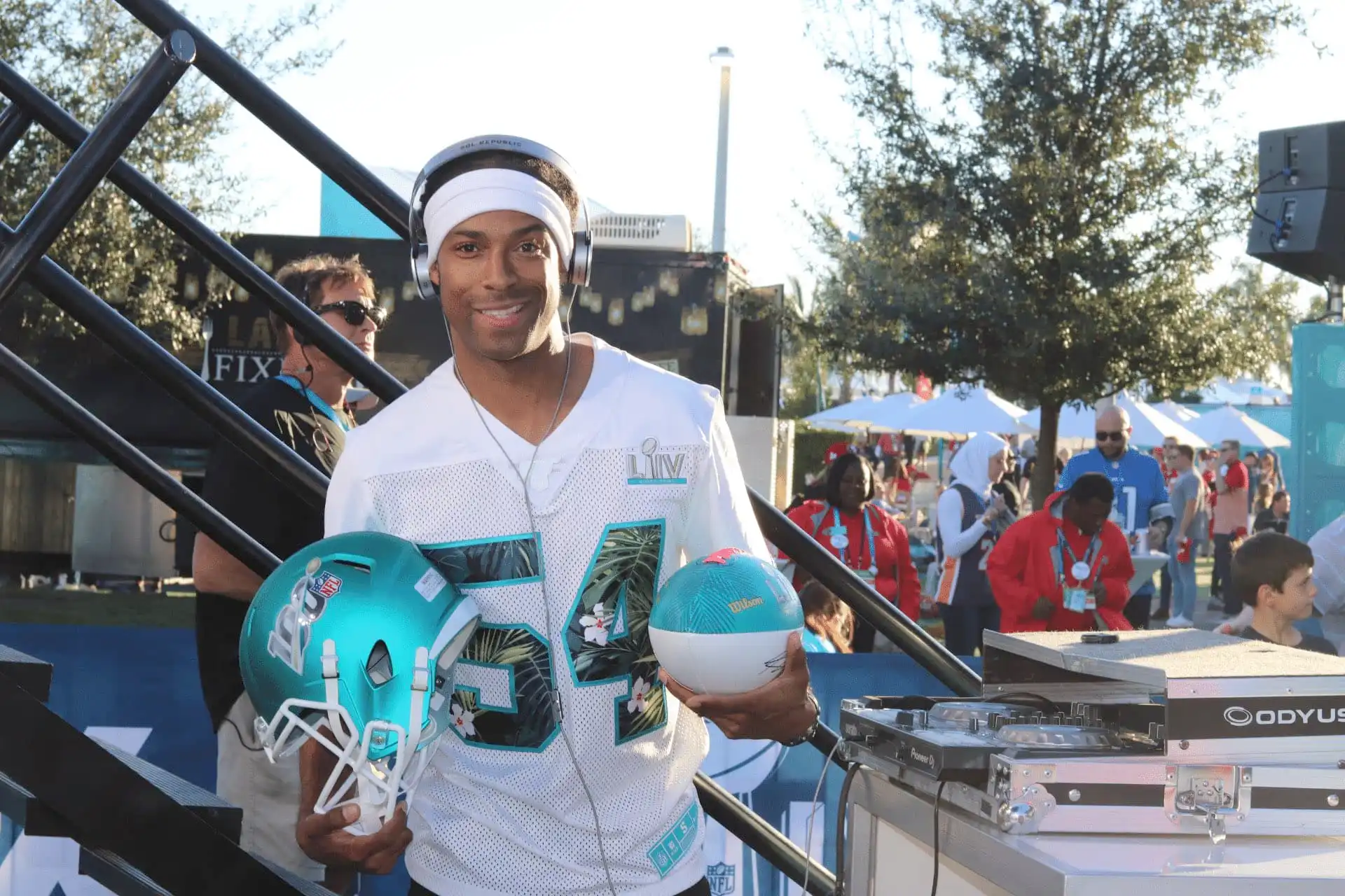 Marrakech Corporate Event DJ Will Gill at Superbowl, holding a football helmet