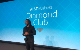 Marrakech Corporate Event Emcee Will Gill on stage in front of a backdrop that says AT&T business diamond club