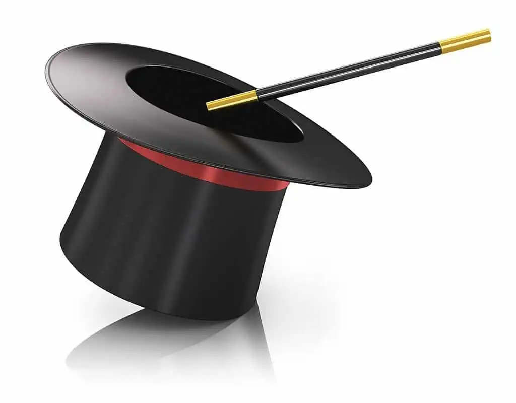 A black mentalist top hat with a red band, tilted at an angle, and a black magic wand with gold tips resting across the hat