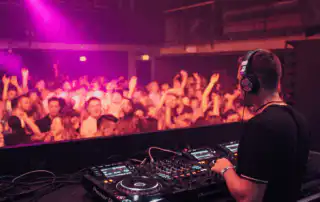 A DJ song selection performing on professional Pioneer DJ equipment