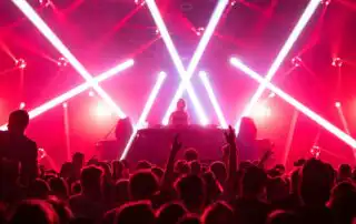 A DJ sets is being played in front of a large crowd