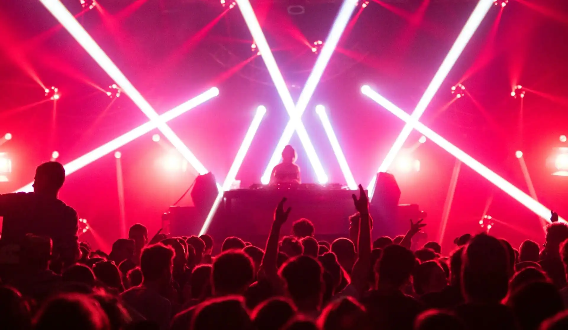 A DJ sets is being played in front of a large crowd