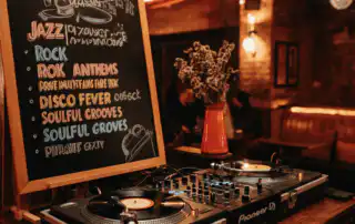 A DJ booth with turntables showing types of playlists