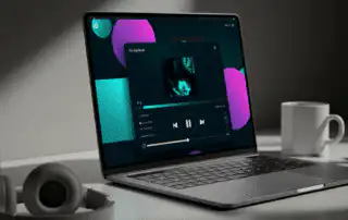 A laptop showing a song streaming service