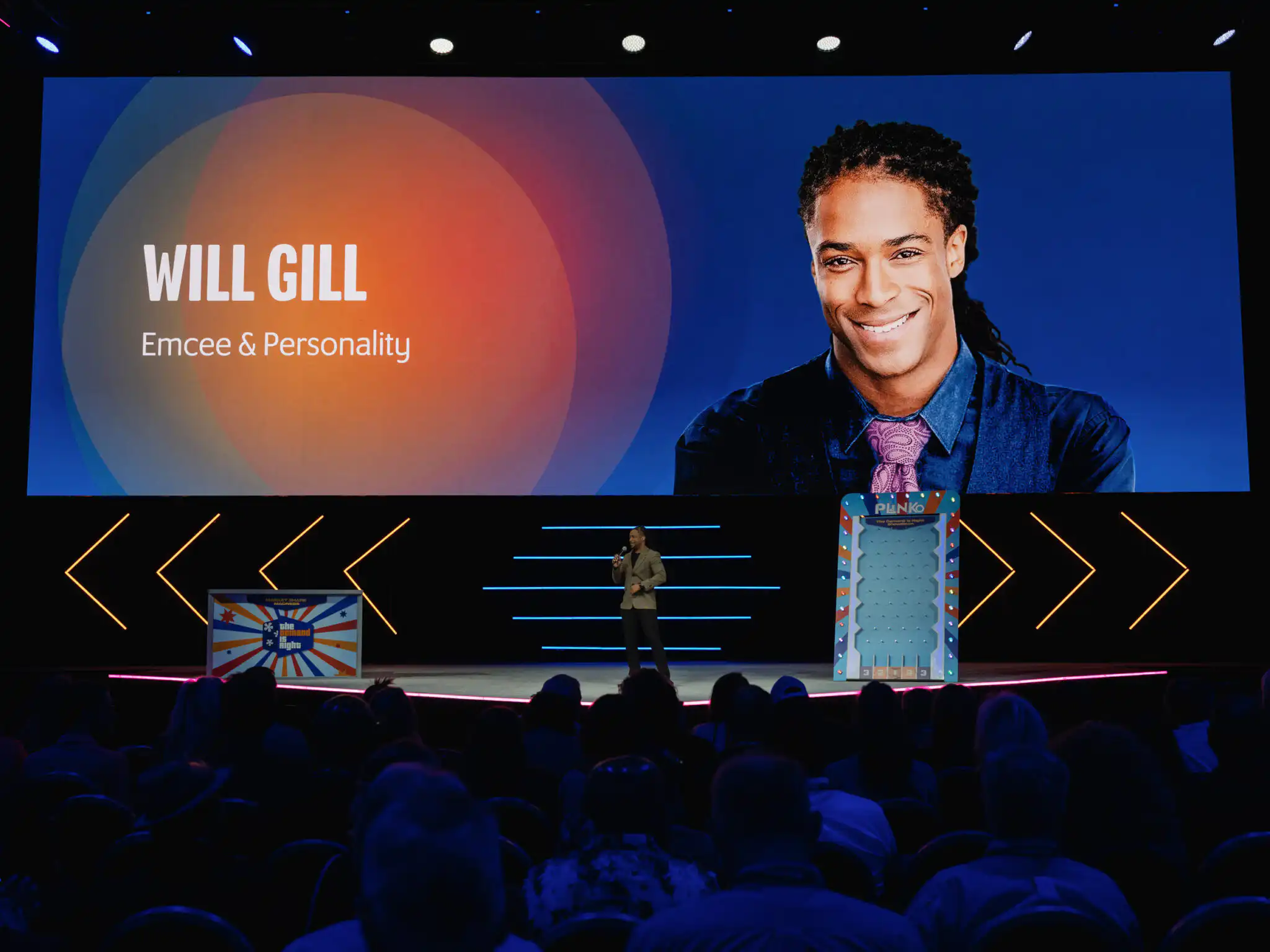 Denver Corporate Event DJ Will Gill is onstage talking with a picture of him on the big screen