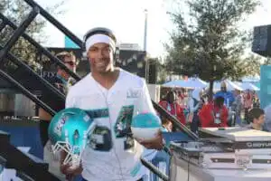 Corporate event in Miami featuring DJ Will Gill at Superbowl, holding a football helmet Corporate event in Miami featuring DJ Will Gill at Superbowl, holding a football helmet
