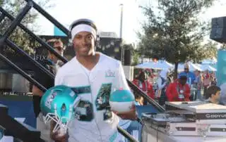 Corporate event in Miami featuring DJ Will Gill at Superbowl, holding a football helmet