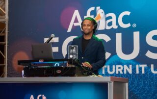 DJ Will Gill at the DJ controller during an Aflac corporate event