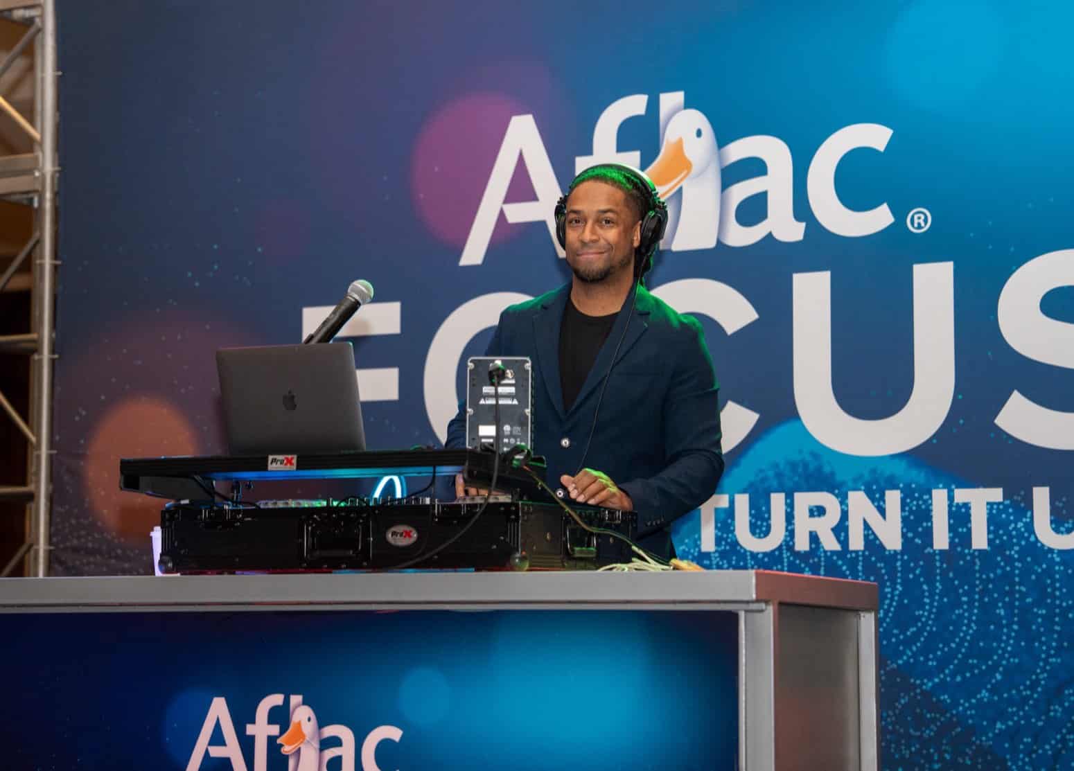 DJ Will Gill at the DJ controller during an Aflac corporate event