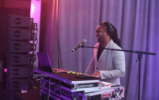DJ Will Gill performing as a corporate event DJ behind the decks